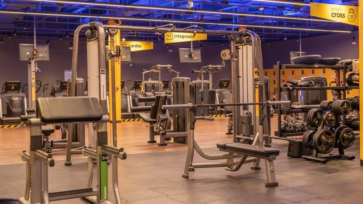 fotografía del area de peso libre del gimnasio smart fit galerías. banco scott, banco plano con soporte para barra.